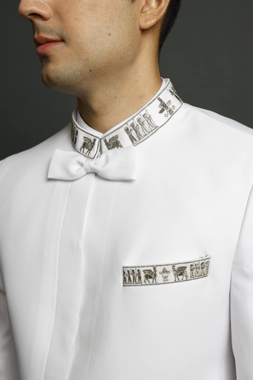 Close-up of embroidered collar and pocket motif on white Dagli